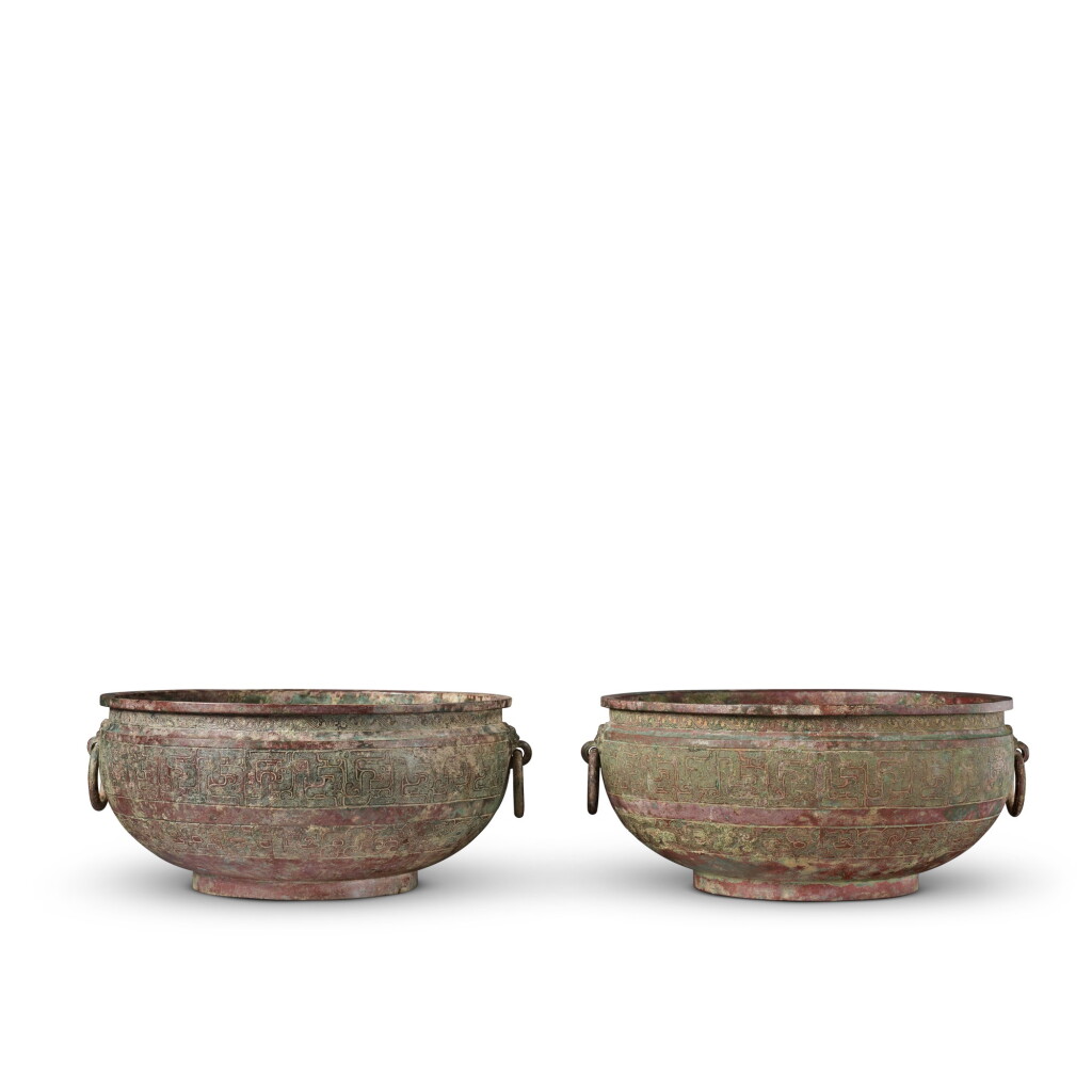 View full screen - View 1 of Lot 16. A pair of archaic bronze water basins (Jian), Eastern Zhou dynasty, late 6th - early 5th century BC | 東周 公元前六世紀末至五世紀初 青銅交龍紋鋪首耳鑒一對.