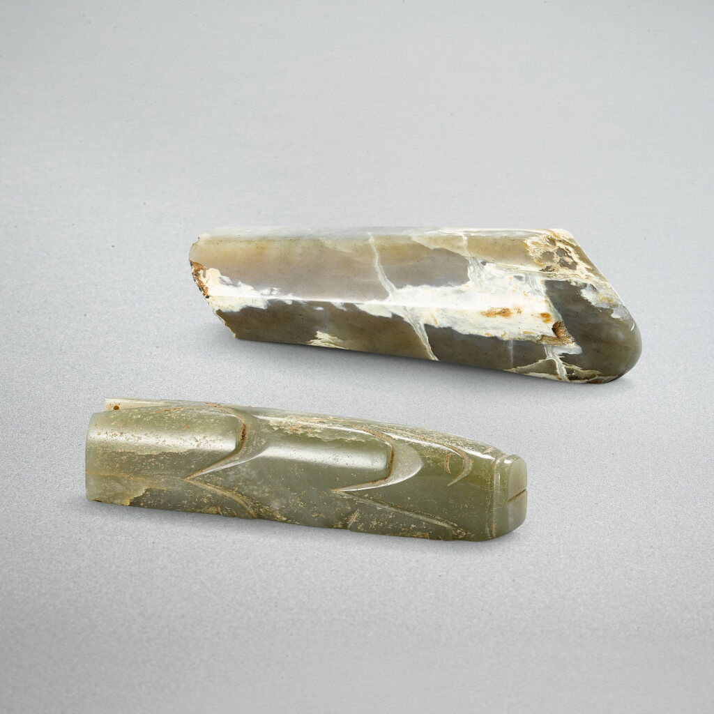 View full screen - View 1 of Lot 764. A greyish celadon jade handle and a celadon jade pig, Han dynasty | 漢 青灰玉六棱形器柄及青玉豬握.