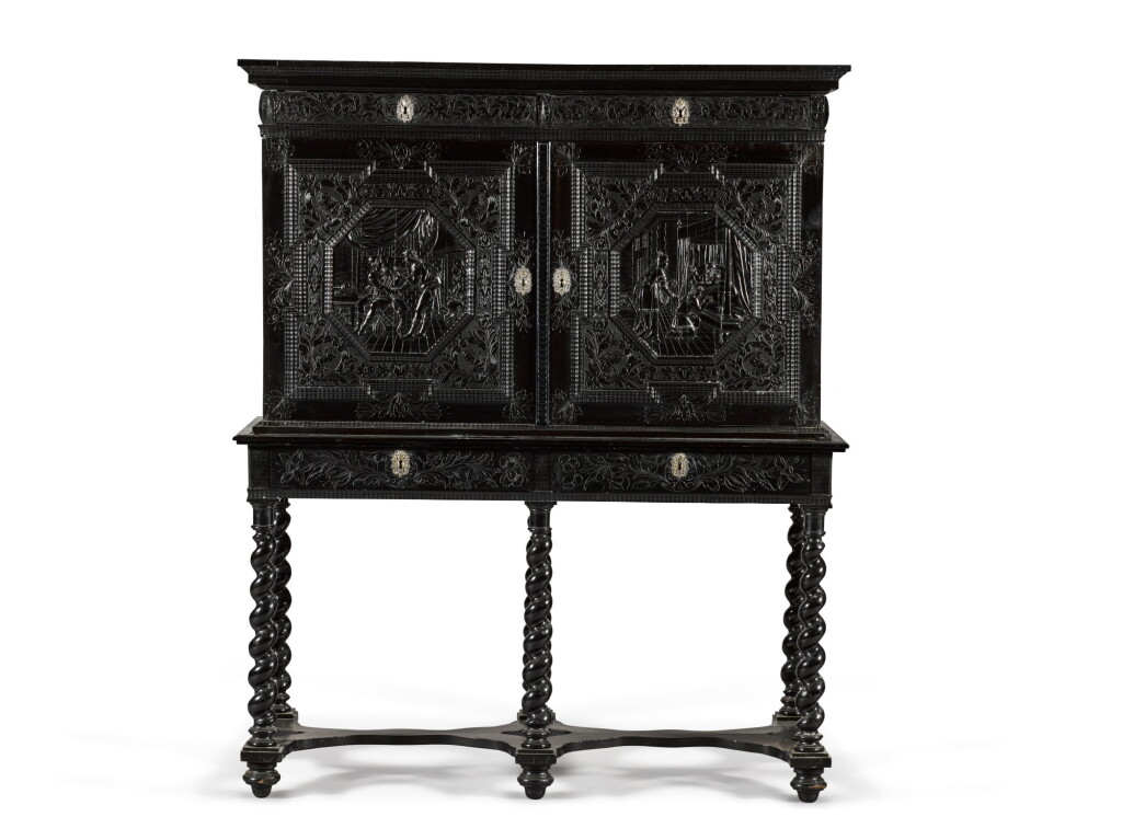 View full screen - View 1 of Lot 15. A Louis XIII silver-mounted carved ebony and ebonised cabinet-on-stand, Paris, second quarter 17th century, the stand partly later.