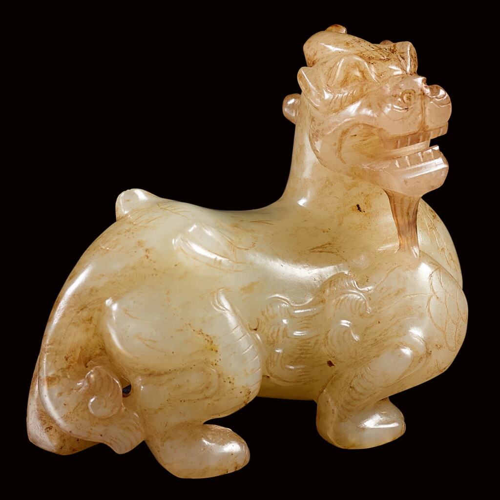 View full screen - View 1 of Lot 40. A RARE CELADON JADE FIGURE OF A BIXIE EASTERN HAN DYNASTY | 東漢 青白玉辟邪.