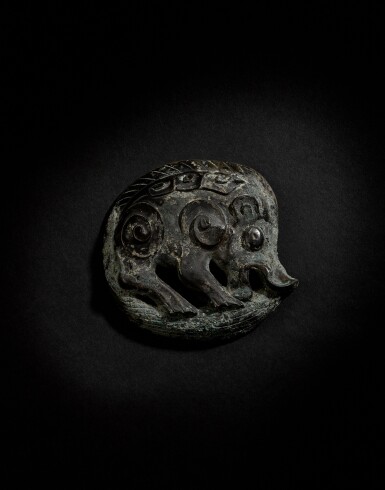 View full screen - View 1 of Lot 140. A very rare archaic bronze 'boar' bridle fitting, Western Zhou dynasty.