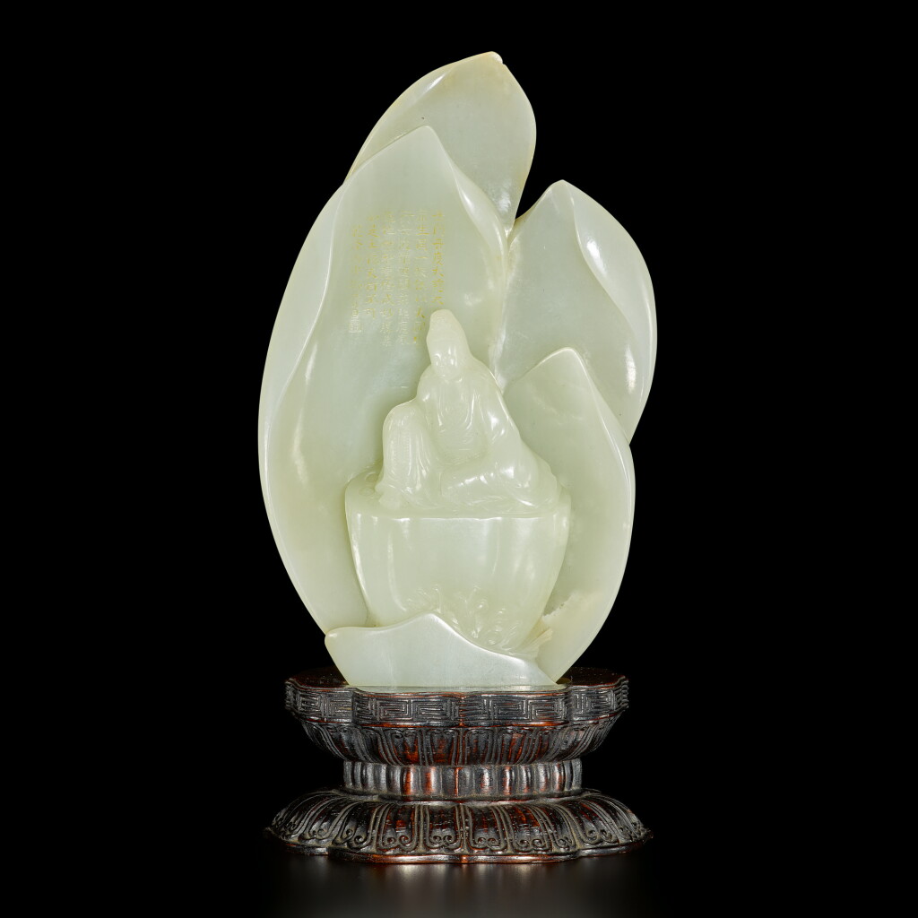 View full screen - View 1 of Lot 182. An inscribed white jade 'Guanyin' boulder, Qing dynasty, 18th / 19th century | 清十八 / 十九世紀 白玉雕蓮花觀音坐像.