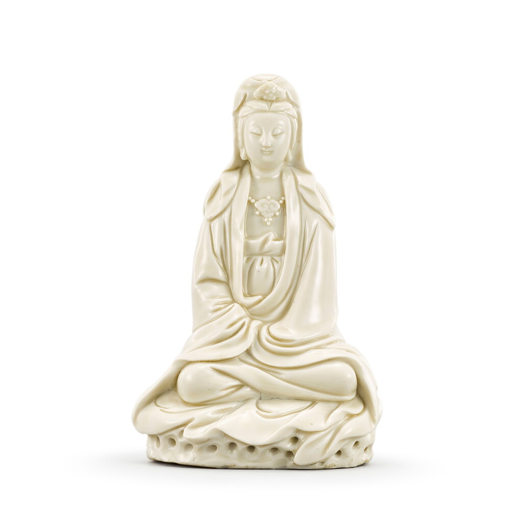 View full screen - View 1 of Lot 437. A DEHUA FIGURE OF GUANYIN LATE MING DYNASTY, CIRCA 1630 | 明末約1630年 德化白釉觀音菩薩坐像.