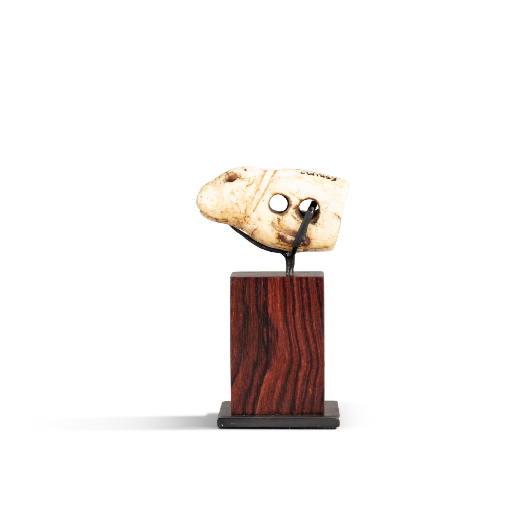 View full screen - View 1 of Lot 139. Inuit Walrus ivory drag harness figuring a seal, Alaska, 19th century | Petit harnais en forme de phoque, Inuit, Alaska, XIXe siècle.