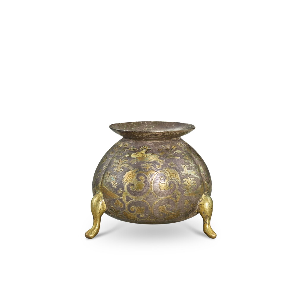 View full screen - View 1 of Lot 3611. A parcel-gilt silver 'floral and animal' tripod incense burner, Tang dynasty | 唐 銀局部鎏金卷草獸紋三足爐.