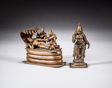 View full screen - View 1 of Lot 117. A bronze figure of Vishnu reclining on the serpent Shesha and a bronze miniature standing figure of Parvati, South India, 16th - 17th century | 南印度 十六至十七世紀 銅毗濕奴立像及銅女神立像一組兩件.