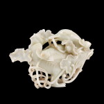 A massive white jade duck-form box and cover, Qing dynasty | 清 白玉寶鴨銜蓮大蓋盒