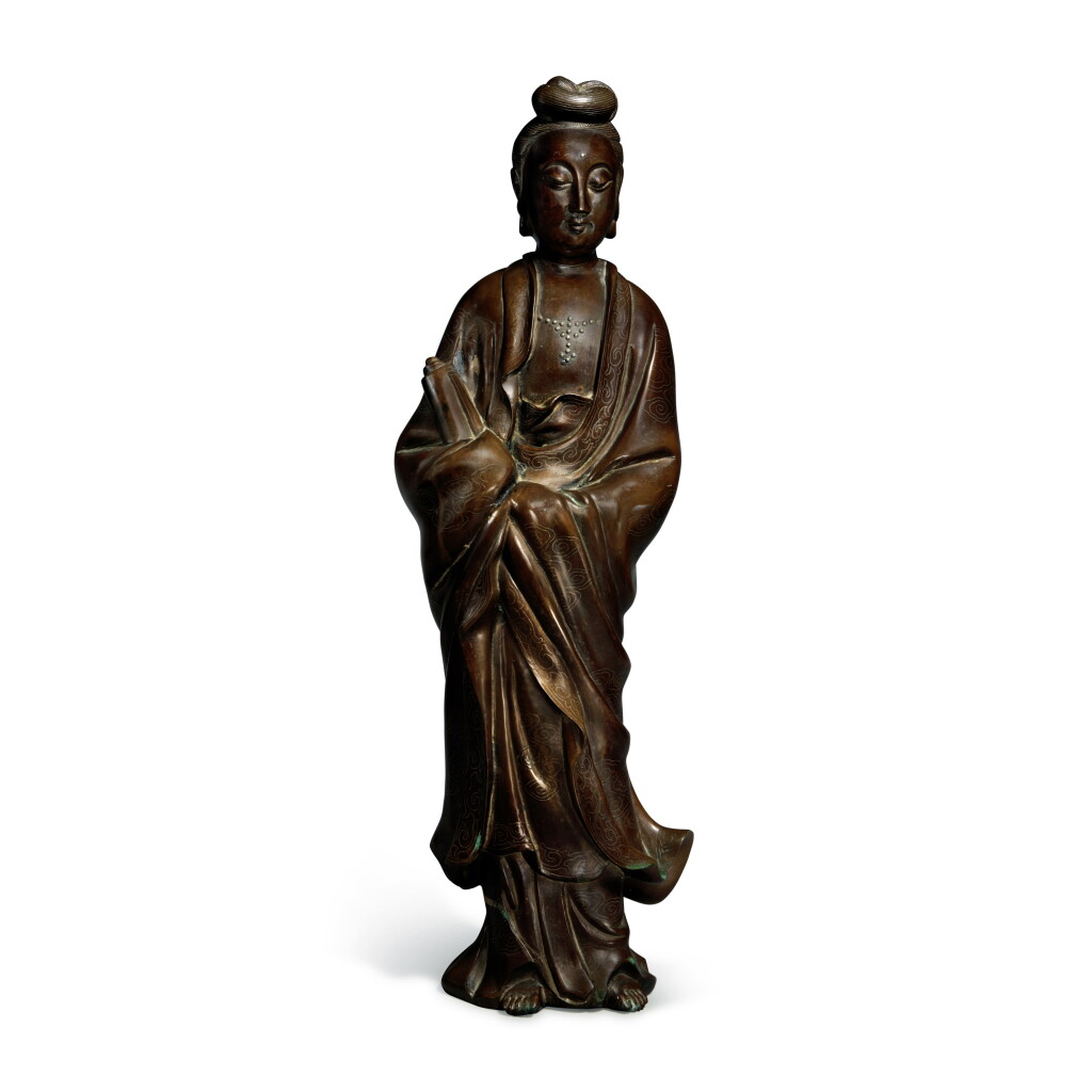 View full screen - View 1 of Lot 405. A silver-inlaid bronze figure of Guanyin, Qing dynasty | 清 銅錯銀觀音立像 《五金石叟》款.