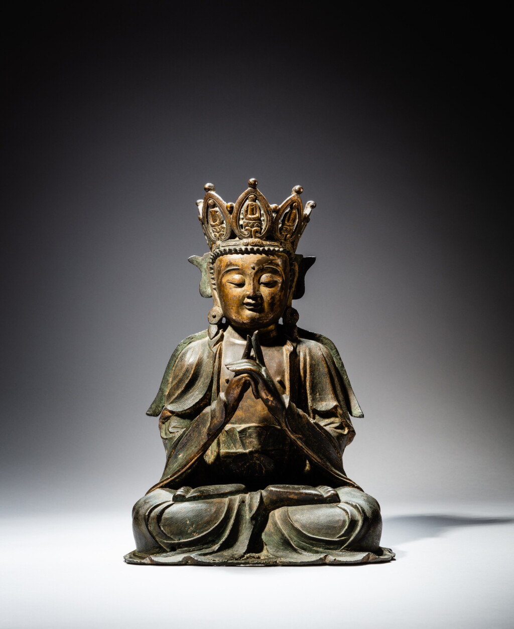 View full screen - View 1 of Lot 100. A bronze figure of Vairochana Buddha, Ming dynasty, 17th century | 明十七世紀 普明大日如來佛坐像.