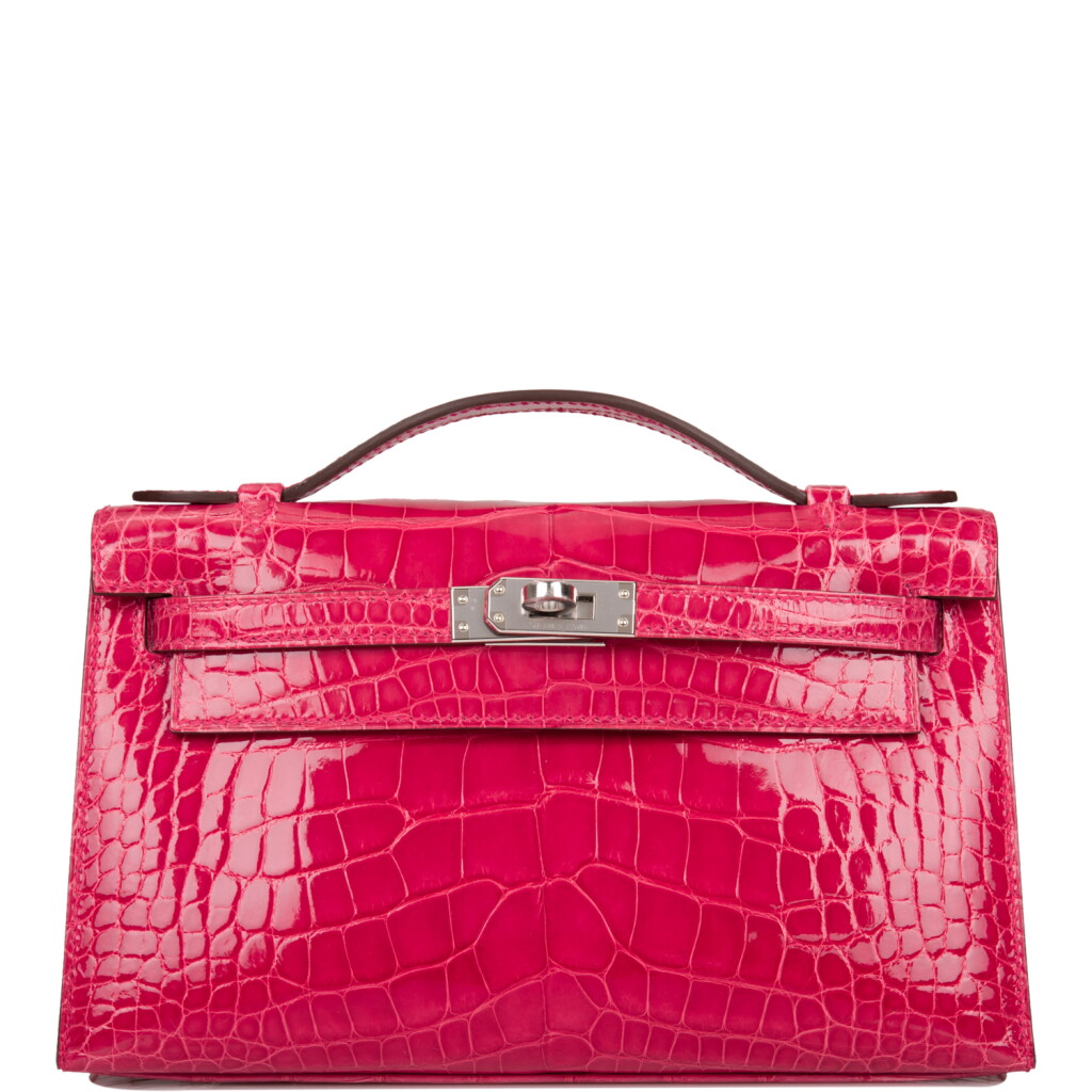 View full screen - View 1 of Lot 31. Hermès Rose Extreme Mini Kelly Pochette of Shiny Mississippiensis Alligator Palladium Hardware.