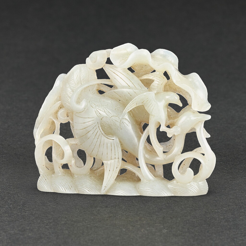 View full screen - View 1 of Lot 553. A CELADON JADE RETICULATED 'GOOSE AND HAWK' GROUP QING DYNASTY | 清 青白玉春水飾.