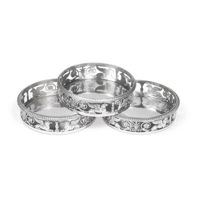 View full screen - View 1 of Lot 252. Three Matching German Silver Empire-Style Wine Coasters, Munich, 1816/32/39.