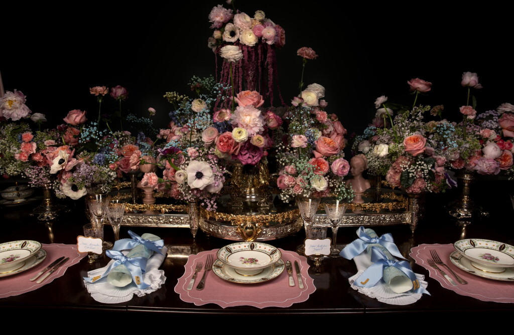 View full screen - View 1 of Lot 43. The Emperor’s Table | A magnificent 18th century George III dining table with 12 Chippendale style carved chairs, a 36 branch St Louis crystal chandelier and an elegant Sevres dinner service made for Emperor Napoleon I, silver candelabra by Odiot, a service of antique cutlery and an impressive mirror and silver-plate plateau centrepiece.