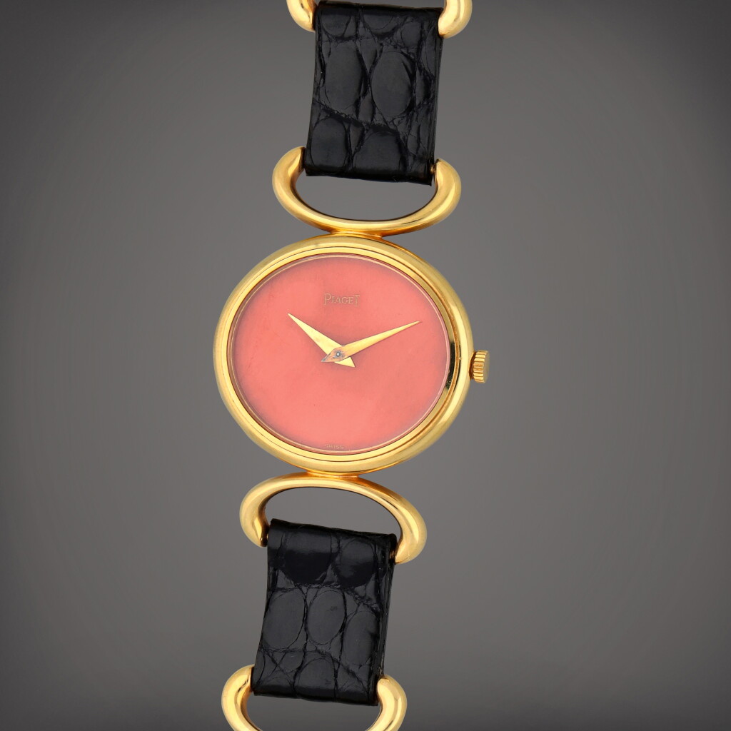 View full screen - View 1 of Lot 328. Reference 9802 D | A yellow gold bracelet watch with coral dial | Circa 1970.