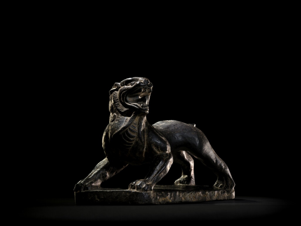 View full screen - View 1 of Lot 9802. A very rare black limestone carving of a lion, Six Dynasties, 6th century | 六朝六世紀 黑石灰岩雕獅像.