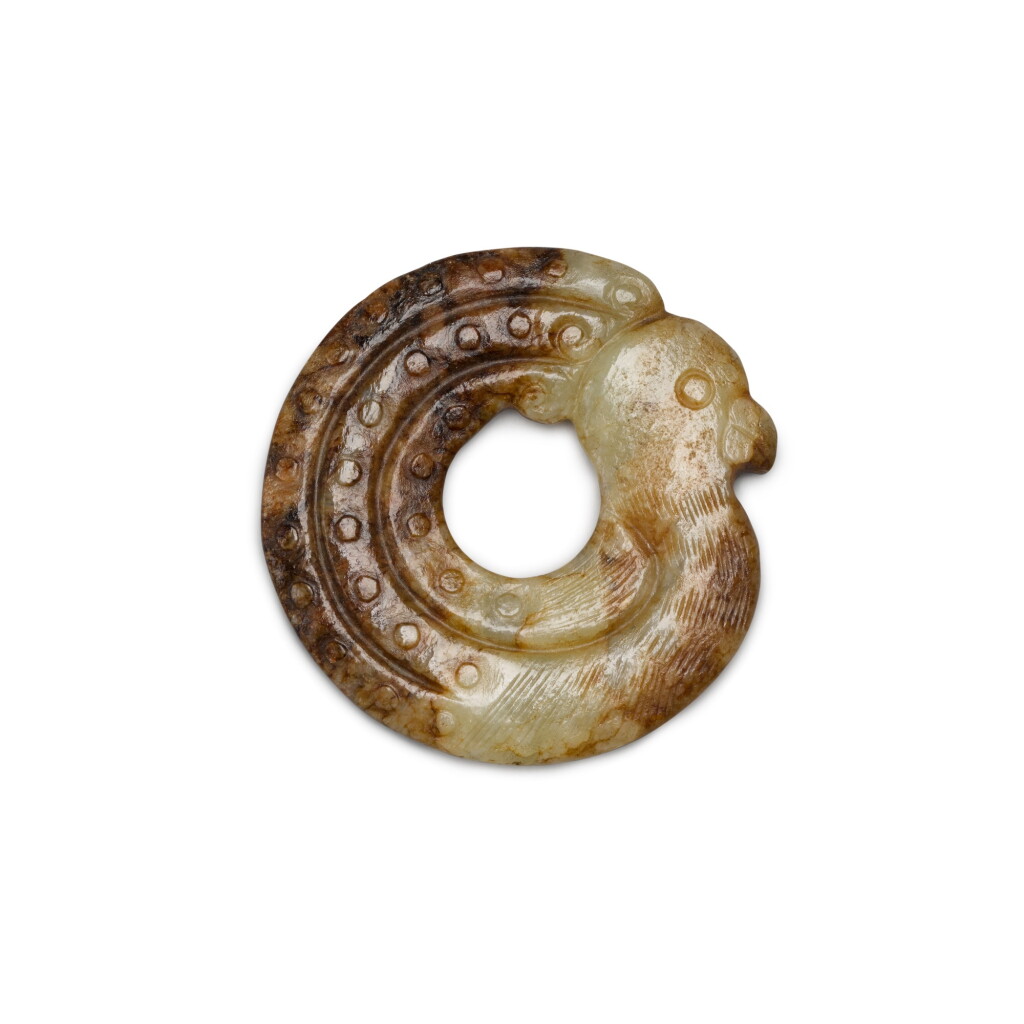 View full screen - View 1 of Lot 66. An archaistic small celadon and russet jade bird-shaped pendant | 褐斑青玉仿古鳥形珮.