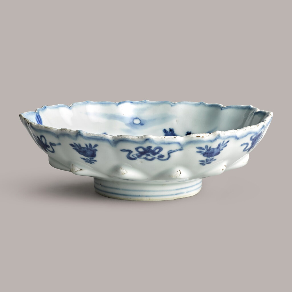 View full screen - View 1 of Lot 358. A blue and white moulded 'mountain' dish Ming Dynasty, Wanli period | 明萬曆 青花瀟湘烟雨圖花口盤.