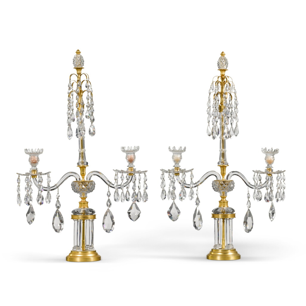 View full screen - View 1 of Lot 19. A pair of George III cut-glass and gilt-brass twin-light candelabra, circa 1790, attributed to Parker and Perry.