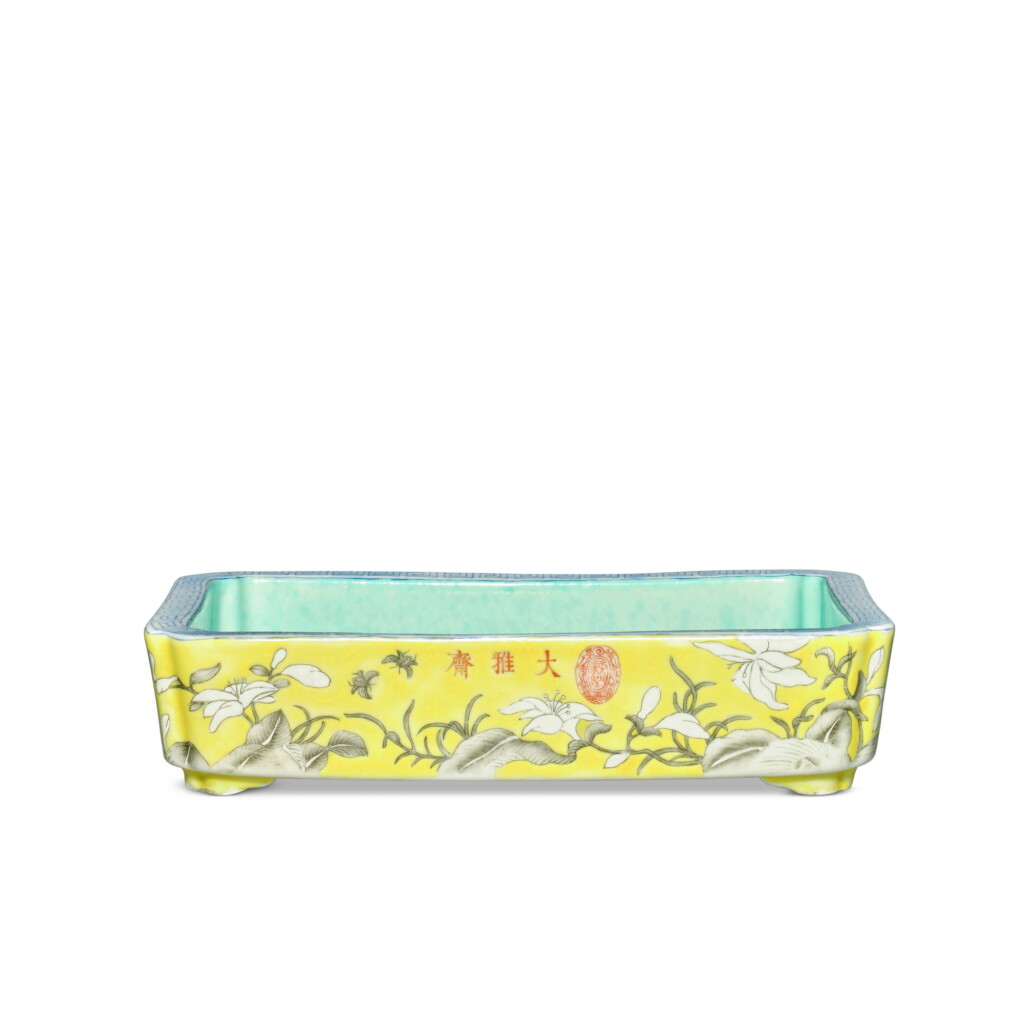 View full screen - View 1 of Lot 599. A yellow-ground famille-rose and grisaille-painted 'Dayazhai' 'day lily' narcissus tray, Qing dynasty, Guangxu period, circa 1876 | 清光緒 約1876年 黃地墨彩萱花紋長方水仙花盆 《大雅齋》《天地一家春》《永慶長春》款.