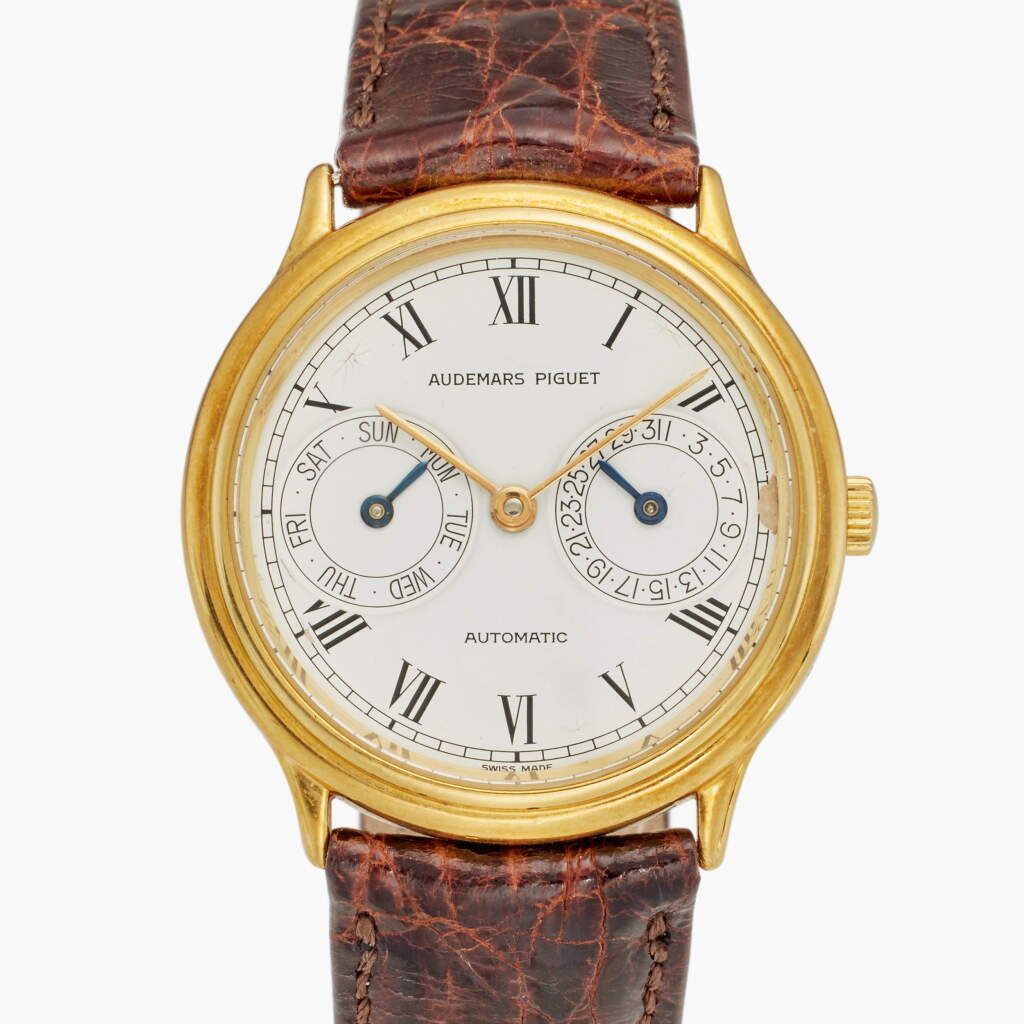 View full screen - View 1 of Lot 165. Reference 25574BA 'Owl' | A yellow gold automatic wristwatch with day, date and enamel dial, Circa 1985.