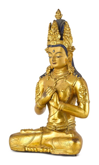 A LARGE GILT-BRONZE FIGURE OF VAIROCANA, TIBET, THE FIGURE CIRCA 1900, THE STAND CIRCA 1400 | 約1900年 藏傳鎏金銅毗盧遮那佛坐像 配 約1400年 鎏金銅蓮座