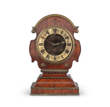 View full screen - View 1 of Lot 26. A gilt bronze, kingwood and amaranth "Tête de poupée" clock, French Regence, circa 1720 | Pendule tête de poupée en placage de bois de violette et d'amarante, bonze doré, Régence, vers 1720.