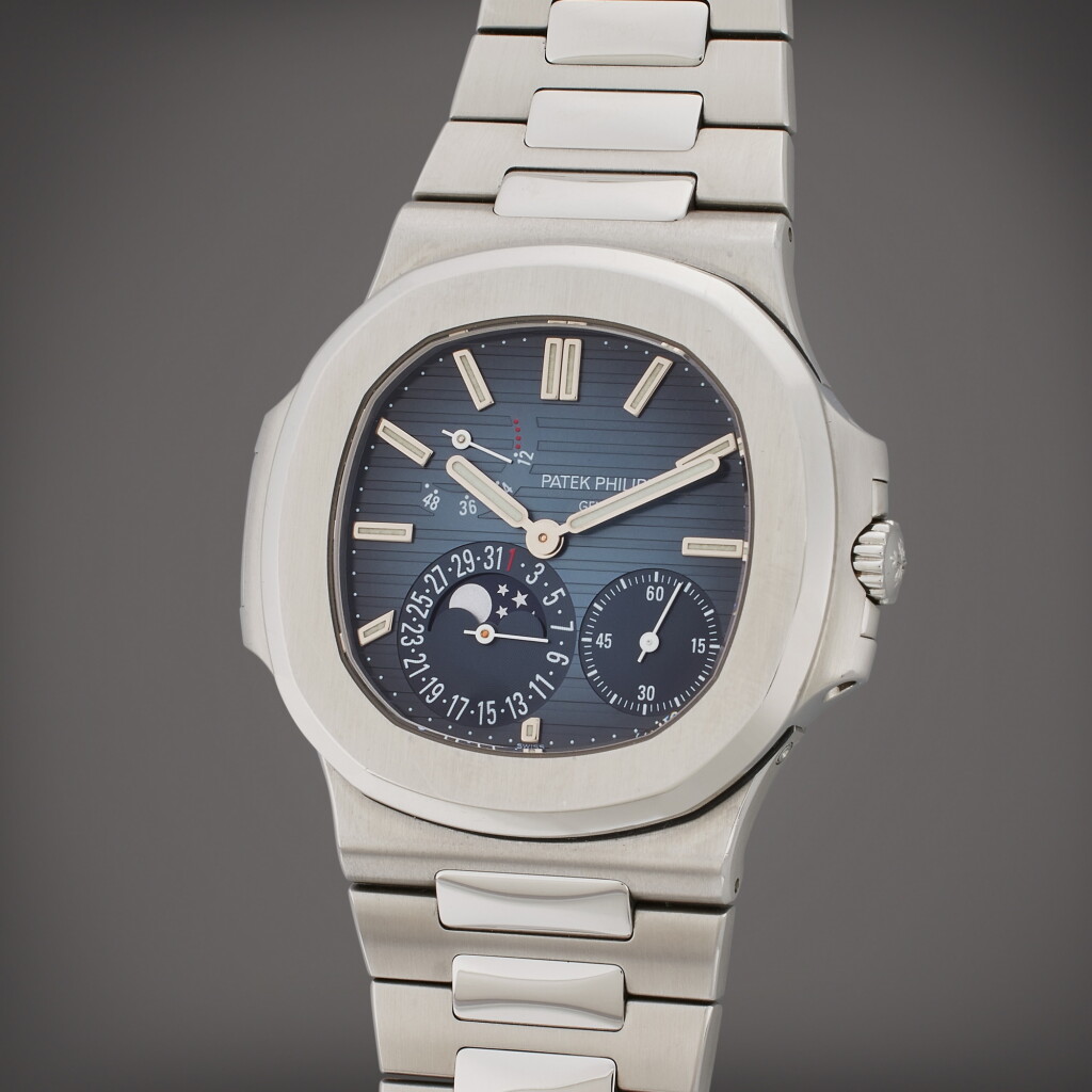 View full screen - View 1 of Lot 153. Reference 5712/1A-001 Nautilus | A stainless steel automatic wristwatch with date, bracelet, moon phases and power reserve indication, Circa 2009 .