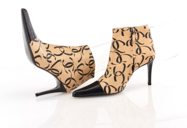 View full screen - View 1 of Lot 41. PAIR OF BEIGE AND BLACK LEATHER CC LOGO ANKLE BOOTS, CHANEL.