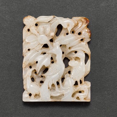 View full screen - View 1 of Lot 554. A GREYISH JADE RETICULATED 'PEACOCK' PLAQUE LIAO - JIN DYNASTY | 遼至金 灰白玉鏤雕孔雀花卉珮飾.