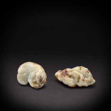 View full screen - View 1 of Lot 6882. A pale celadon and russet jade carved elephant and a 'lion and cub' group, Late Ming to early Qing dynasty | 明末清初 青玉象形墜飾及太獅少獅墜飾.