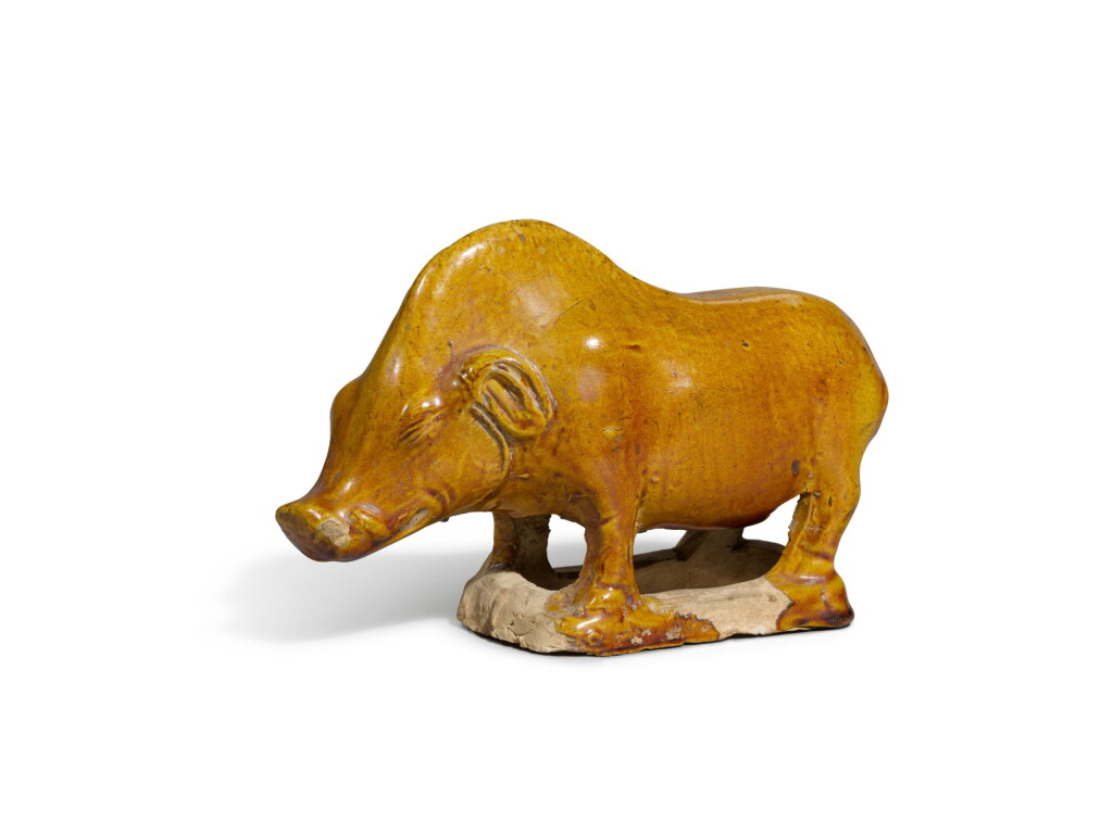 View full screen - View 1 of Lot 8. A chestnut-glazed pottery figure of a boar, Tang dynasty | 唐 黄褐釉野豬.