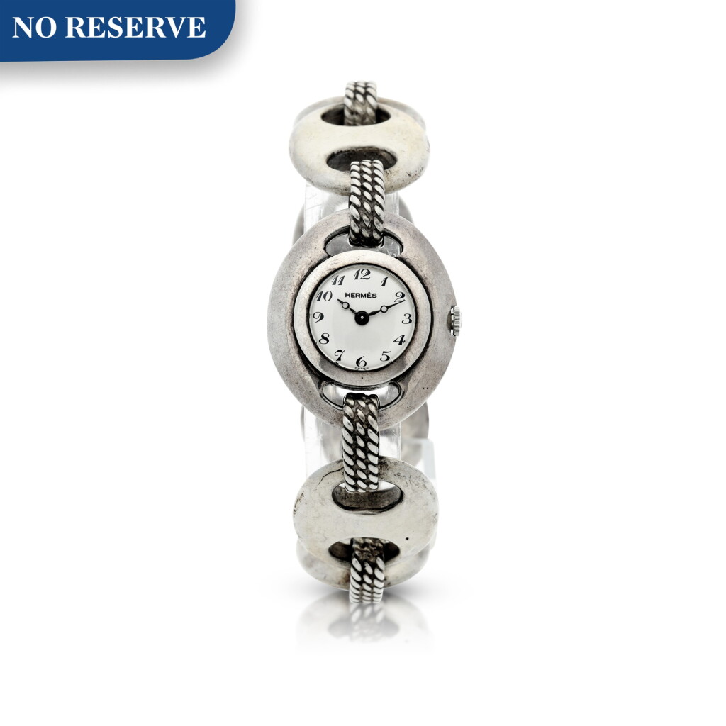 View full screen - View 1 of Lot 238. RETAILED BY HERMES: A LADY'S STERLING SILVER BRACELET WATCH, CIRCA 1955.