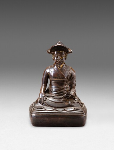 View full screen - View 1 of Lot 119. A rare copper-alloy figure of a Drukpa Kagyu Lama Tibet or Bhutan, ca. 17th century | 西藏或不丹 約十七世紀 銅合金竹巴噶舉喇嘛坐像 .