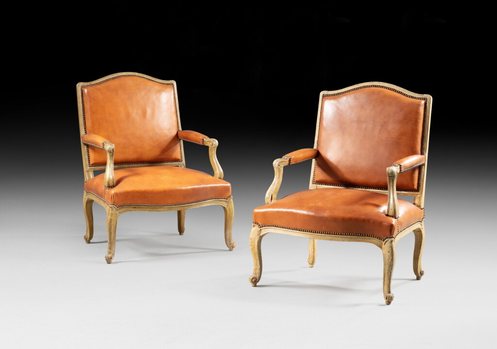View full screen - View 1 of Lot 31. A pair of re-lacquered armchairs, Louis XV, circa 1730 | Paire de fauteuils en bois relaqué crème d'époque Louis XV, vers 1730.