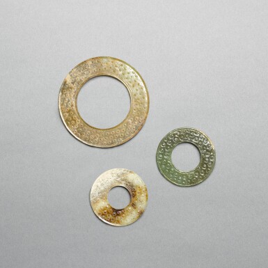View full screen - View 1 of Lot 735. A small pale celadon jade disc, huan, and two celadon jade discs, yuan, Eastern Zhou dynasty, Spring and Autumn period | 東周春秋 青白玉榖紋環一件及瑗兩件.