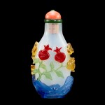 A four-colour overlay glass 'sanduo' snuff bottle, Qing dynasty, 19th century | 清十九世紀 半透明地套四色料三多紋鼻煙壺