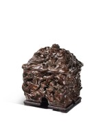 An extremely rare chenxiangmu 'nine-dragon' vessel and cover, fangyi, Qing dynasty, Qianlong period | 清乾隆 沉香木雕九龍紋方彜 木座「乙」字