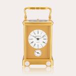 A gilt brass and porcelain hour striking carriage clock with alarm, circa 1980