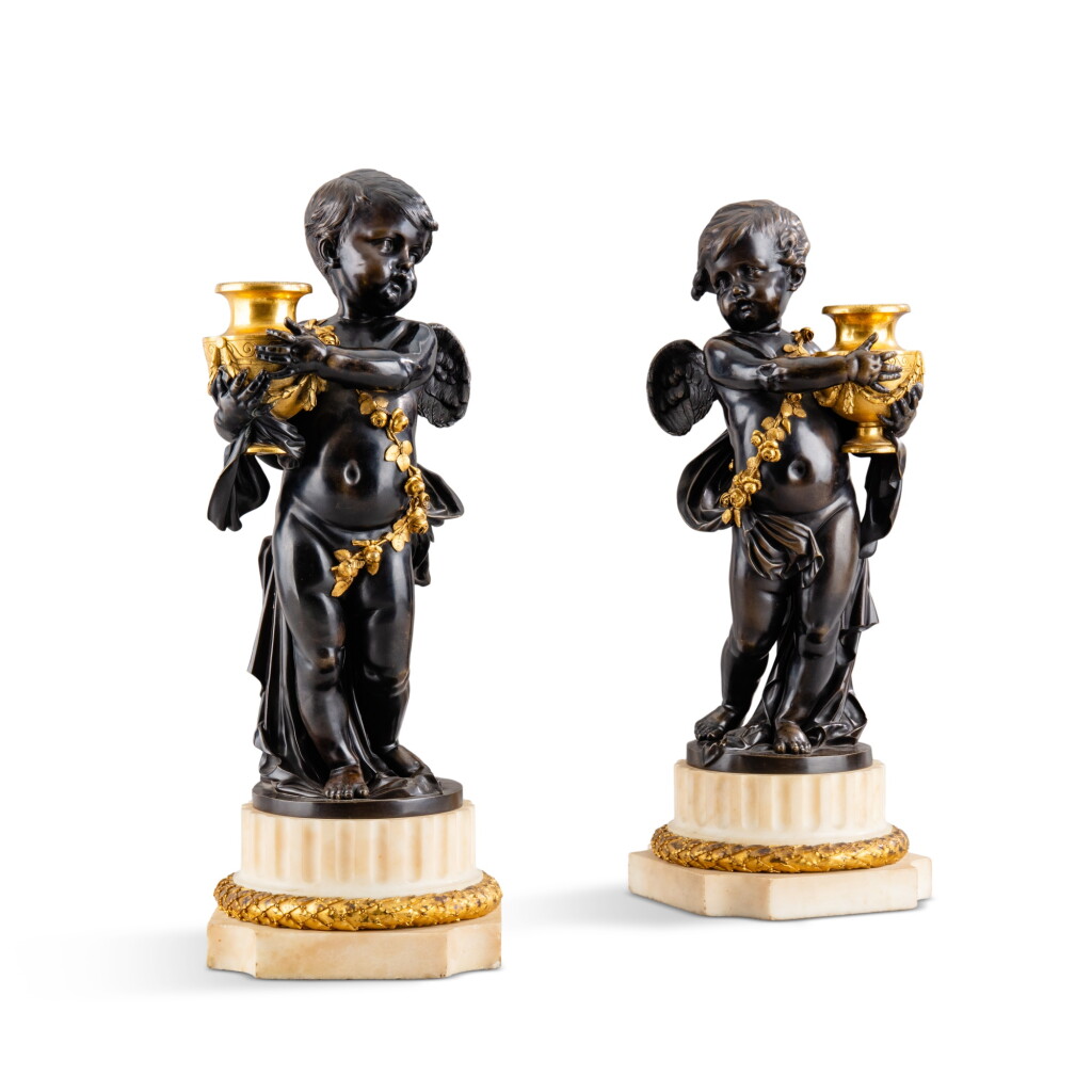 View full screen - View 1 of Lot 448. A pair of Louis XVI style patinated and gilt-bronze angels, late 19th century | Paire d’angelots en bronze doré et patiné de style Louis XVI, fin XIXe xiècle .