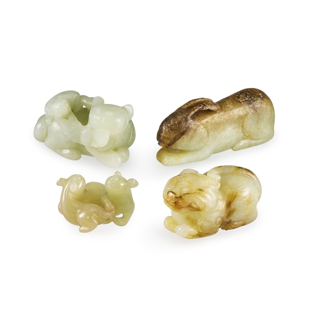 View full screen - View 1 of Lot 2120. A jade rabbit, a jade tiger, a jade badger group and a jade ‘cat and butterfly’ group Qing dynasty | 清 玉臥兔、伏虎、雙獾及耄耊一組四件 .