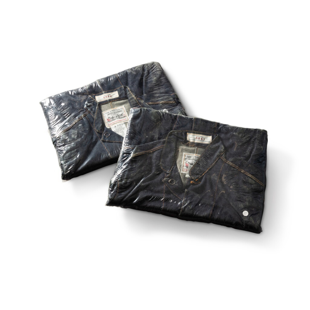 View full screen - View 1 of Lot 148. Two Levi Strauss jean jackets forming a cover for two magazines.