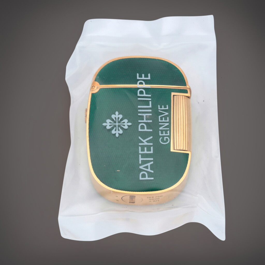 View full screen - View 1 of Lot 387. Golden Ellipse, Reference 9508 | A sealed yellow gold and green enamel lighter | Circa 1980.