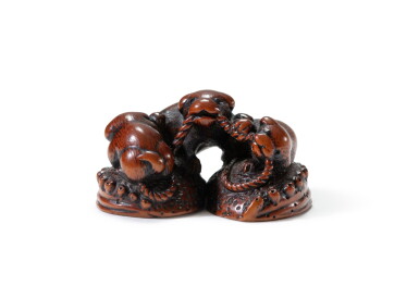 View full screen - View 1 of Lot 189. A carved wood study of three puppies playing on abalones, Tokyo School, early 19th century | 日本 十九世紀早期 木雕三犬根付.