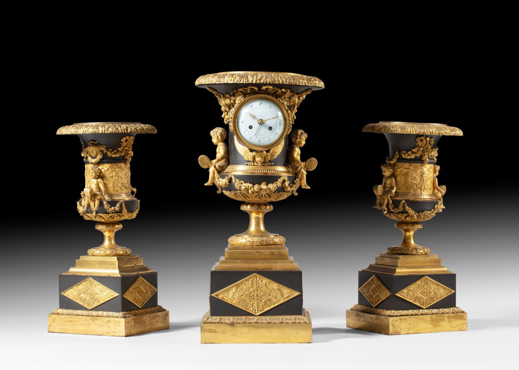 View full screen - View 1 of Lot 137. A patinated and gilt-bronze garniture de cheminée, French Empire, circa 1810 | Garniture de cheminée en bronze patiné et doré d'époque Empire, vers 1810.