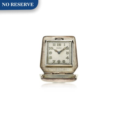 View full screen - View 1 of Lot 100. A silver purse shaped travel clock, Circa 1930.