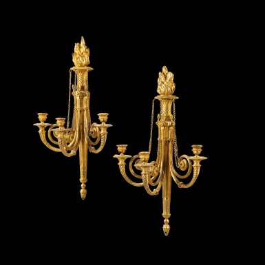 View full screen - View 1 of Lot 35. A pair of three-light wall lights, Louis XVI, circa 1780, attributed to François Rémond | Paire d'appliques à trois lumières en bronze doré d'époque Louis XVI, vers 1780, attribuée à François Rémond.
