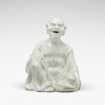 A Meissen white porcelain figure of a seated pagod, Circa 1715