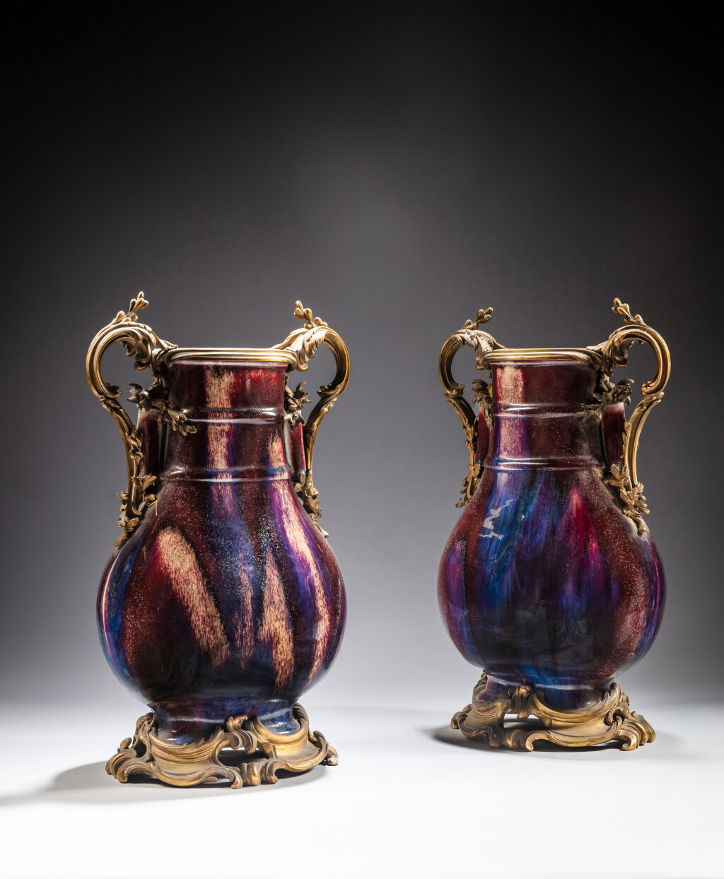 View full screen - View 1 of Lot 13. A pair of gilt-bronze mounted flambé-glazed vases (Hu), Qing dynasty, 19th / 20th century | 清十九 / 二十世紀 窰變釉壺鎏金銅座一對.