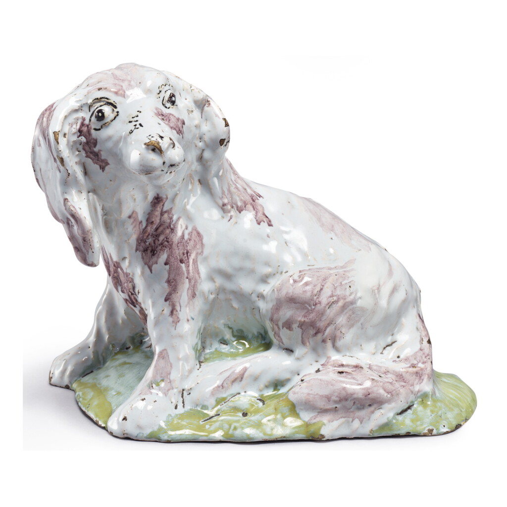 View full screen - View 1 of Lot 679. A BRUSSELS FAIENCE FIGURE OF A SEATED SPANIEL, LATE 18TH CENTURY.