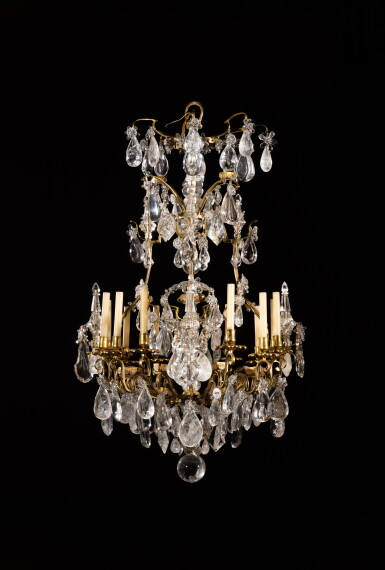 View full screen - View 1 of Lot 143. A Louis XV style varnished-bronze, rock crystal and glass chandelier | Lustre à douze lumières en bronze verni, cristal de roche et verre de style Louis XV.